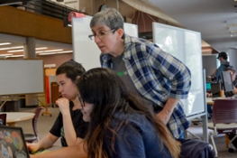 Professor helping students at the hackathon
